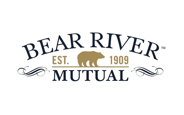 Bear River Insurance sign in Farmington, Utah, with clear blue sky background.